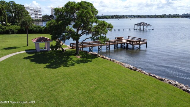 view of dock featuring a water view and a lawn