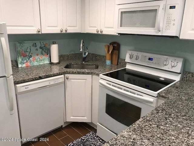 8600 Ridgewood Ave N Unit 1313, Cape Canaveral, FL 32920 - kitchen with white appliances, white cabinetry, and dark stone counters