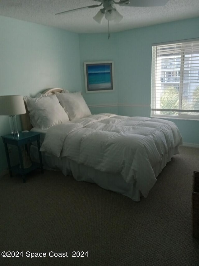 8600 Ridgewood Ave N Unit 1313, Cape Canaveral, FL 32920 - carpeted bedroom with a textured ceiling and ceiling fan