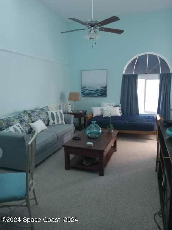 8600 Ridgewood Ave N Unit 1313, Cape Canaveral, FL 32920 - living area featuring carpet flooring, a ceiling fan, and high vaulted ceiling