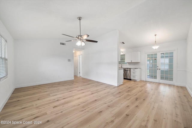 unfurnished living room with light hardwood / wood-style floors, french doors, ceiling fan, and lofted ceiling