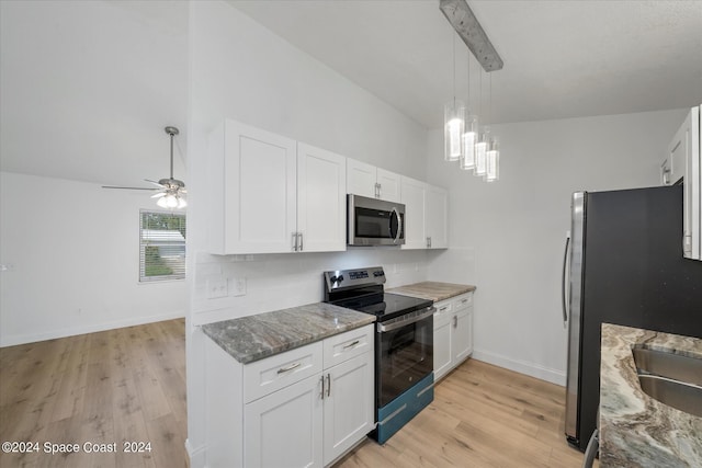 kitchen featuring stainless steel appliances, light hardwood / wood-style flooring, stone counters, white cabinets, and pendant lighting