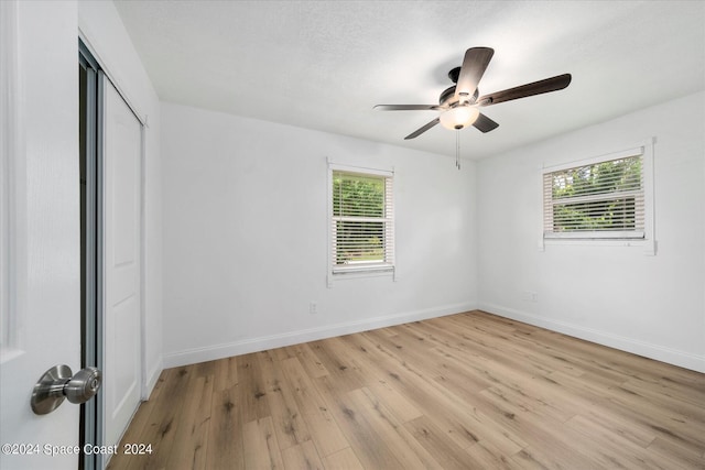 unfurnished room featuring ceiling fan, light hardwood / wood-style flooring, and a wealth of natural light