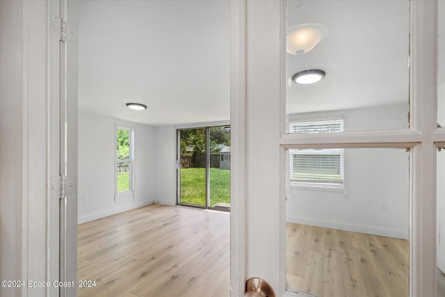 unfurnished room with light hardwood / wood-style floors and a healthy amount of sunlight