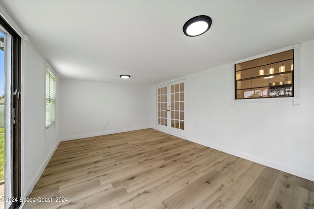 empty room featuring light hardwood / wood-style flooring and french doors