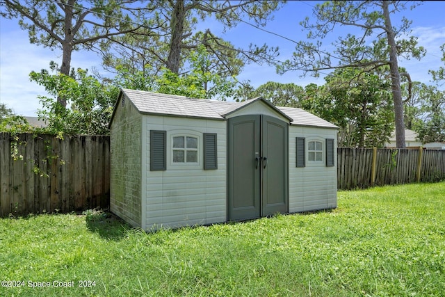 view of outbuilding featuring a yard