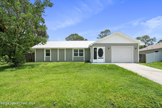 single story home with a garage and a front lawn