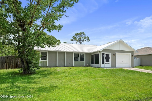 ranch-style house with a garage and a front yard