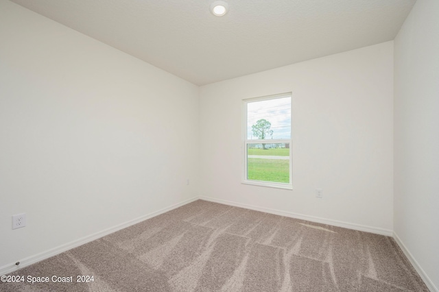 empty room with carpet floors and baseboards