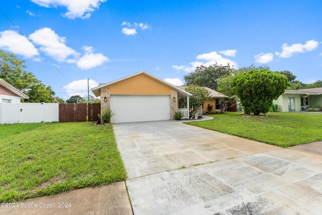 view of front facade with a garage and a front lawn