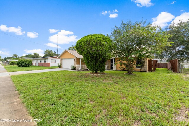 view of front of property with a front yard and a garage