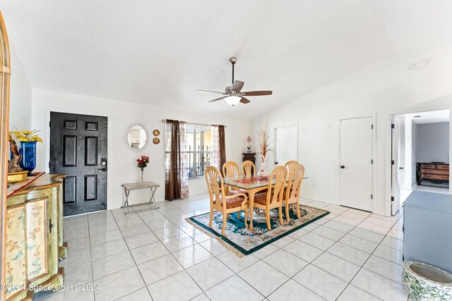 tiled dining room featuring ceiling fan and lofted ceiling