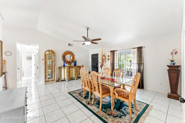 dining area with ceiling fan, vaulted ceiling, and light tile patterned flooring