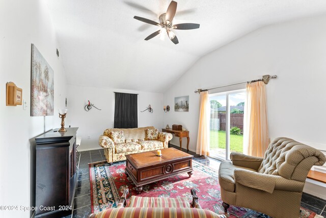 tiled living room featuring ceiling fan and vaulted ceiling