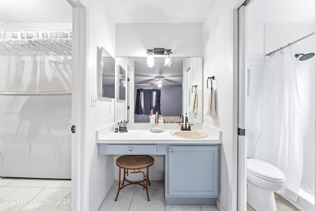 bathroom with tile patterned floors, curtained shower, a textured ceiling, and vanity