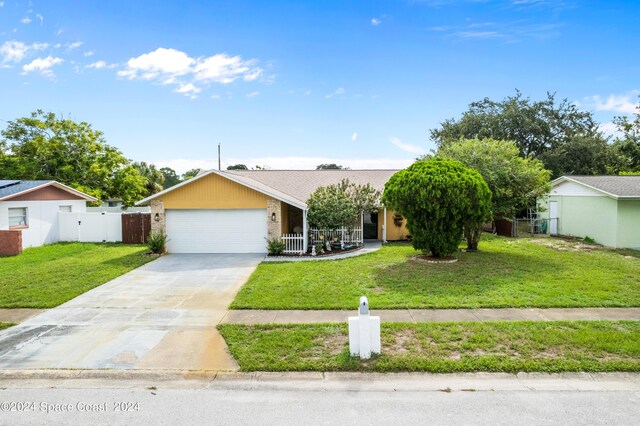 ranch-style home featuring a front yard and a garage