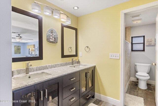 bathroom with ceiling fan, vanity, and toilet