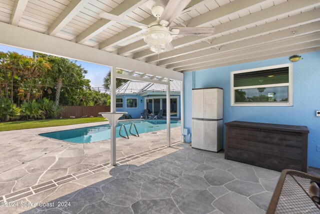 view of pool with ceiling fan, a yard, and a patio