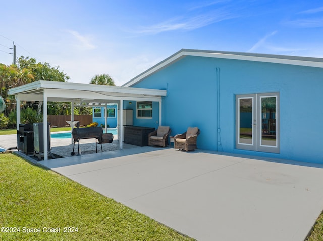 back of house featuring a patio area, outdoor lounge area, and french doors