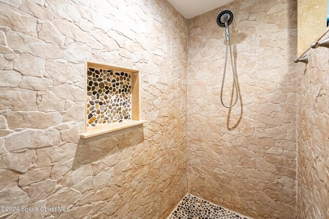 bathroom with tiled shower