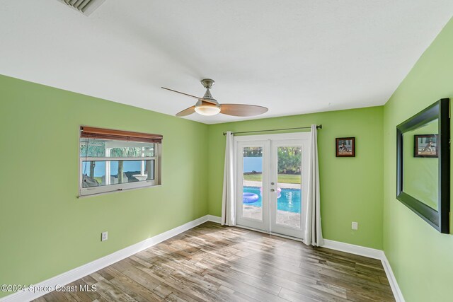 spare room with french doors, hardwood / wood-style flooring, and ceiling fan