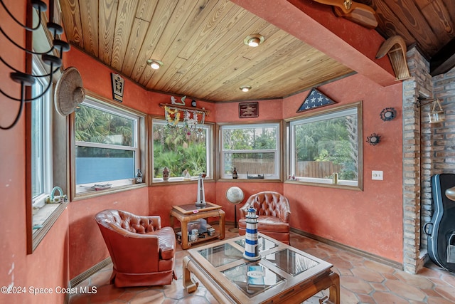 sunroom / solarium featuring baseboard heating and wood ceiling