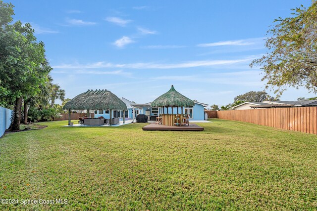 view of yard with outdoor lounge area, a gazebo, and a deck