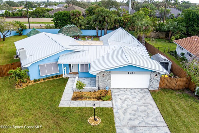 view of front of house with a garage and a front lawn