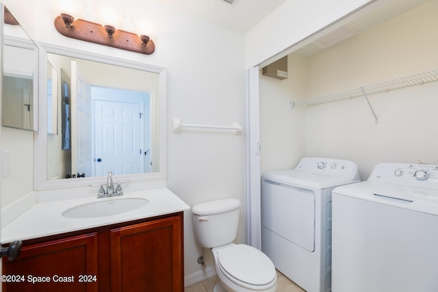 bathroom featuring tile patterned floors, vanity, separate washer and dryer, and toilet