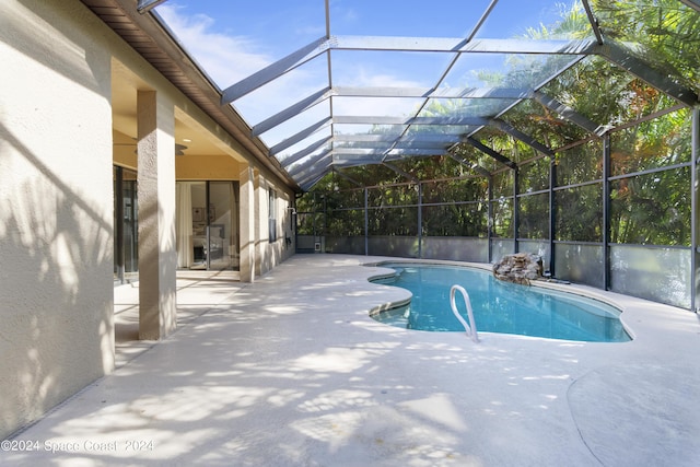 pool featuring a lanai and a patio area