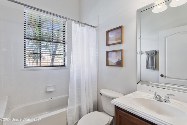 full bath with shower / bath combo, vanity, and toilet