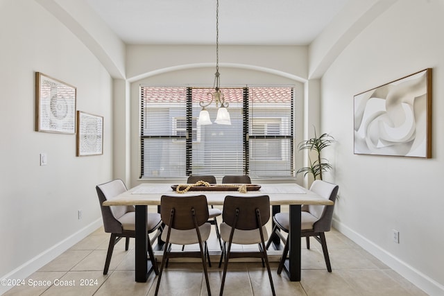 dining area featuring light tile patterned floors and baseboards