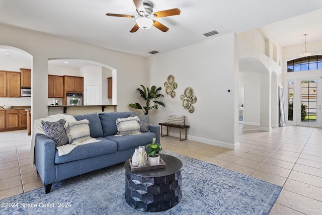 living room with baseboards, visible vents, and light tile patterned flooring