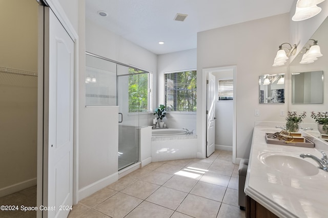 full bath featuring double vanity, a sink, tile patterned flooring, a shower stall, and a bath