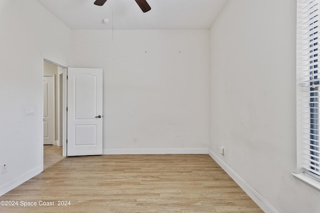 unfurnished room featuring baseboards, ceiling fan, and light wood-style floors