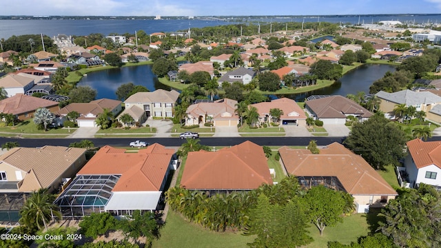 birds eye view of property with a water view and a residential view