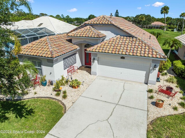 mediterranean / spanish house featuring a garage