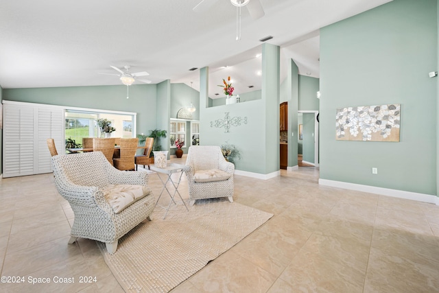 living area with a ceiling fan, high vaulted ceiling, and baseboards