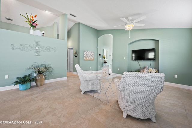 living room with arched walkways, ceiling fan, visible vents, and baseboards