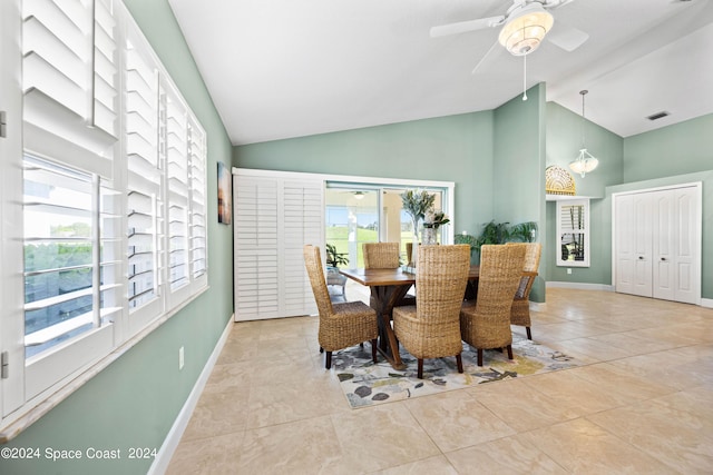 dining room featuring high vaulted ceiling, visible vents, baseboards, and light tile patterned flooring