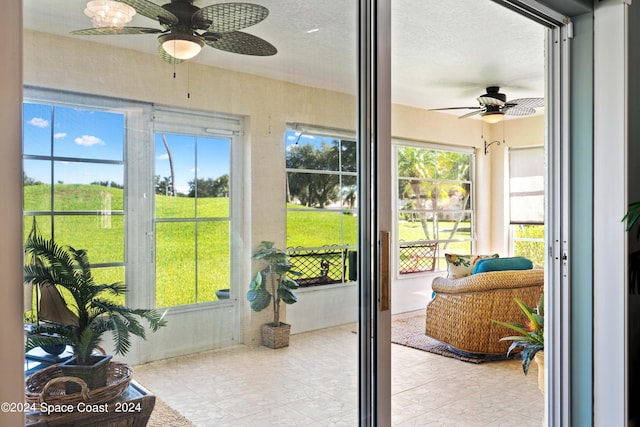 sunroom / solarium with a ceiling fan