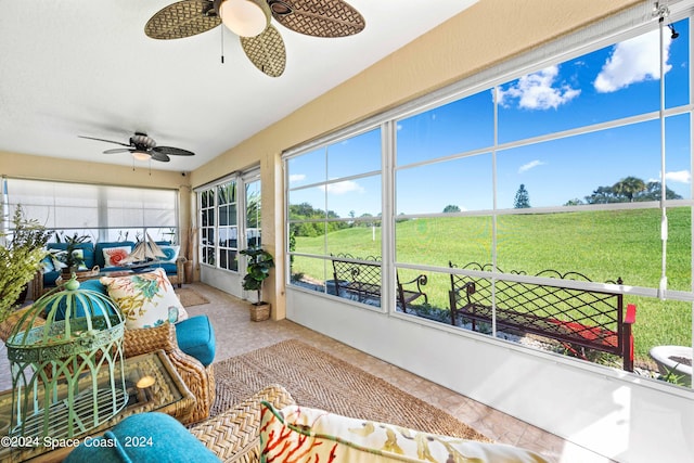 sunroom / solarium with a ceiling fan