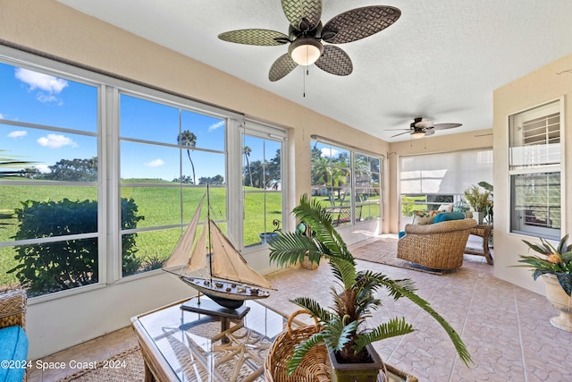 sunroom / solarium featuring ceiling fan