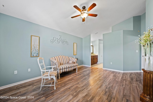 sitting room with lofted ceiling, wood finished floors, a ceiling fan, and baseboards