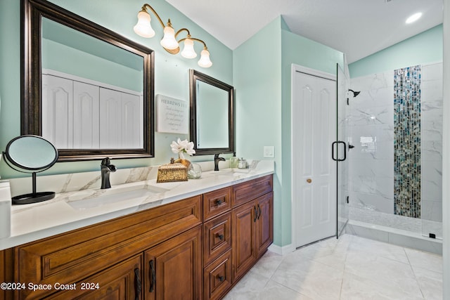 bathroom with a stall shower, a closet, a sink, and double vanity