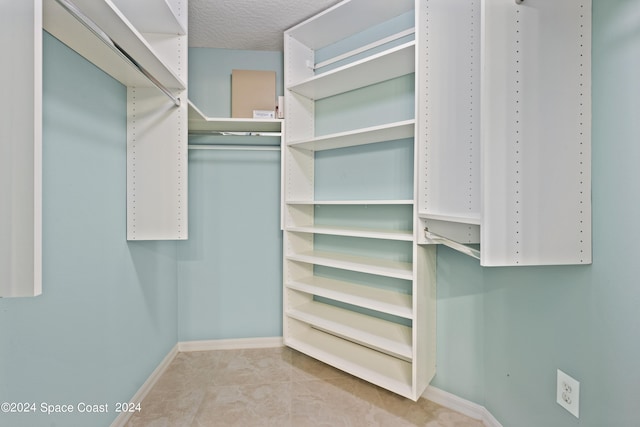 walk in closet featuring light tile patterned floors