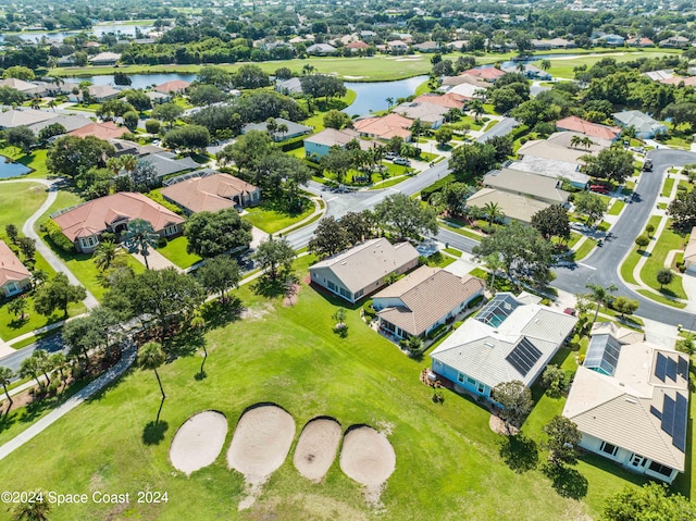 birds eye view of property featuring a water view and a residential view