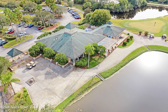 birds eye view of property with a water view and golf course view