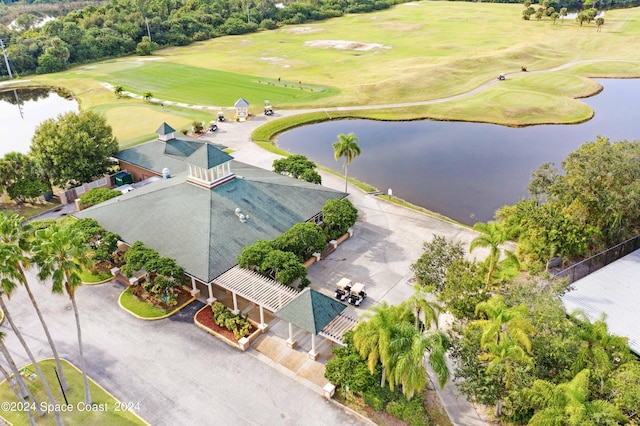 aerial view with golf course view and a water view