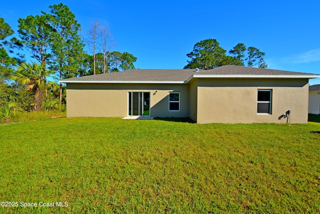 back of property featuring a lawn